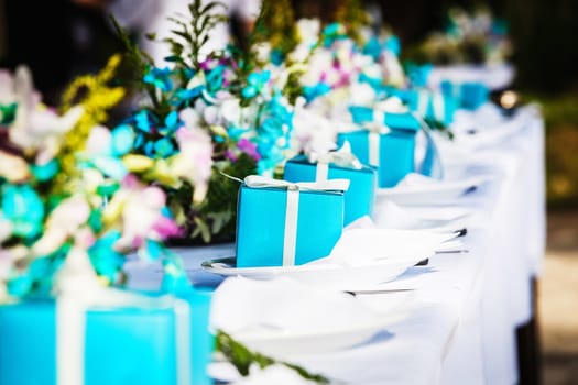 Laid wedding table with gifts and flowers