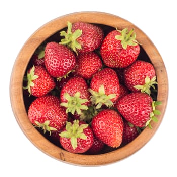 Strawberries in a wooden bowl isolated on white background. top view.