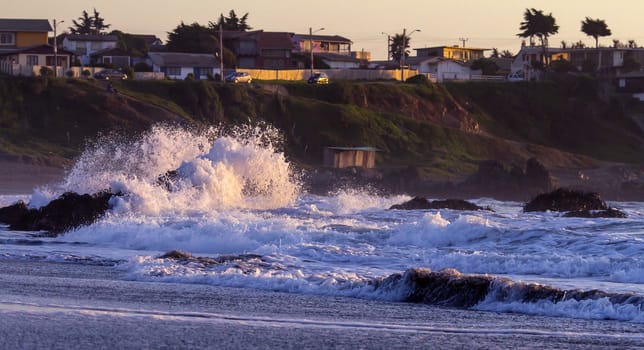 Colorful ocean waves at sunset in Chile