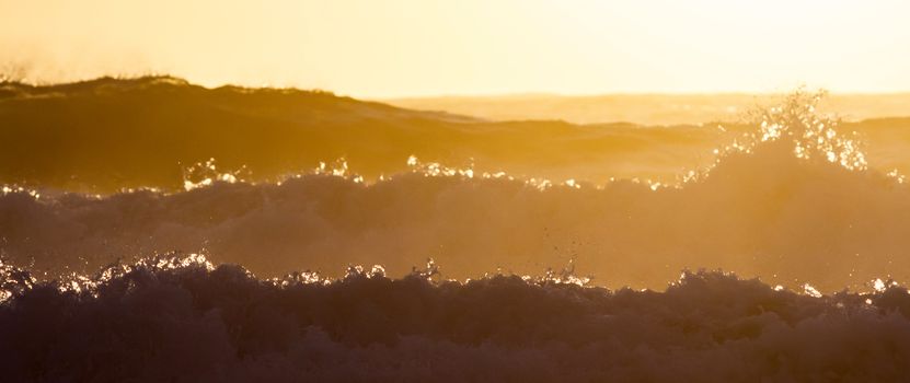 Colorful ocean waves at sunset in Chile