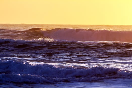 Colorful ocean waves at sunset in Chile