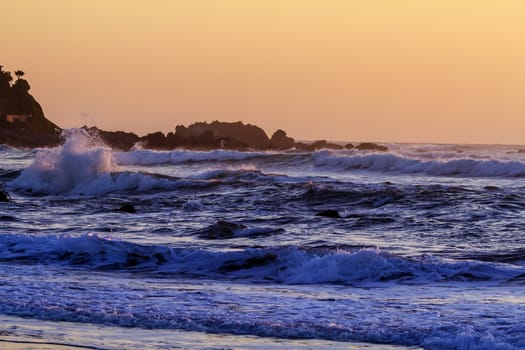 Colorful ocean waves at sunset in Chile