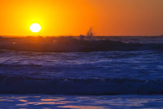 Colorful ocean waves at sunset in Chile