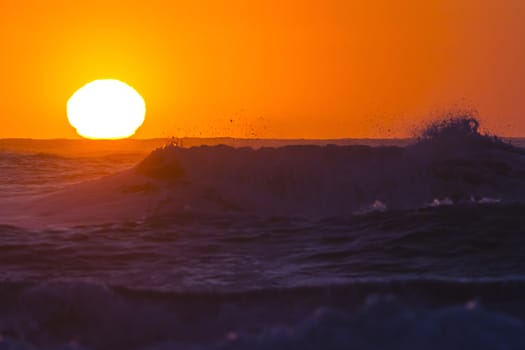 Colorful ocean waves at sunset in Chile