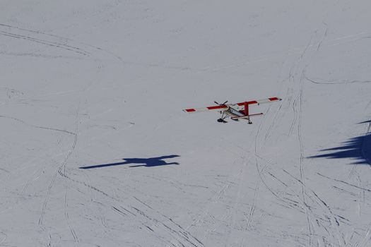 Cessna plane flying on snow background, New Zealand