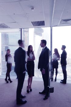 Business people talking in a conference room with city skyline