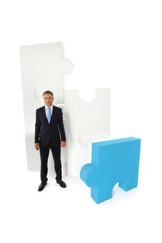 Portrait of business man and puzzle isolated on white background