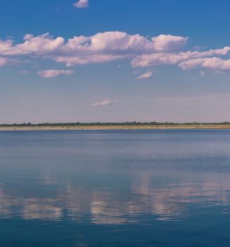 Relaxing water landscape with clouds reflections