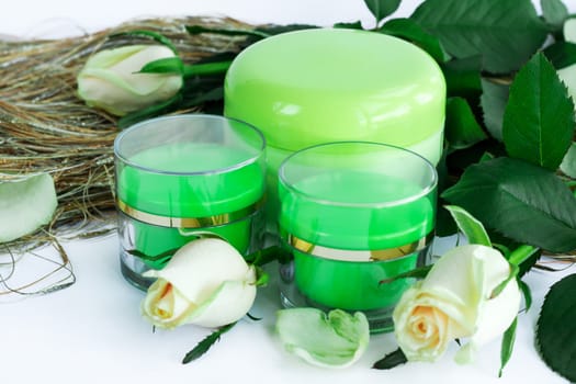 Set of three green cosmetic cream bottles with white roses