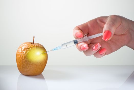 The female hand with beautiful manicure does an injection for smoothing of wrinkles