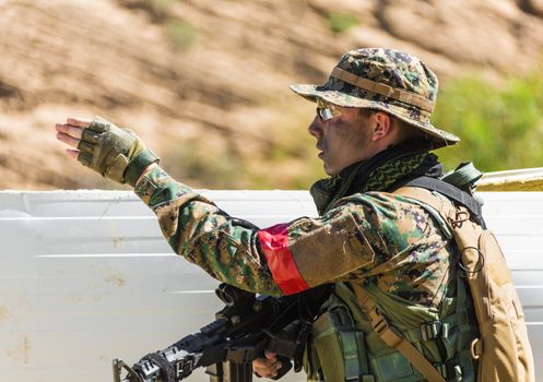 soldier in uniform with weapon on a mission