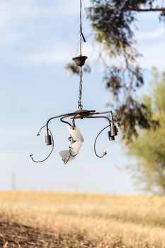 old the broken chandelier hanging on outdoors