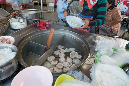 women sell noodle on the boat at traditional floating market.