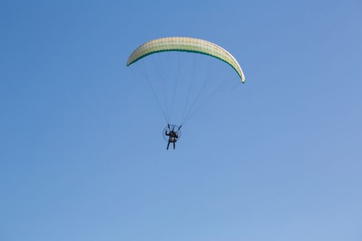 parachutist closeup flying on background blue sky