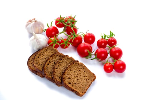 Set of black bread slices, cherry tomatoes and garlic