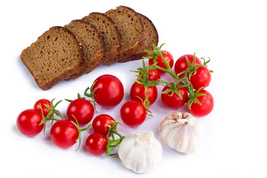 Set of black bread slices, bunch of tomatoes and garlic