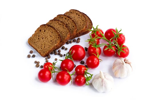 Composition of black bread,  cherry tomatoes and garlic