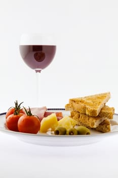 A tasty mediterranean plate match to a red wine glass