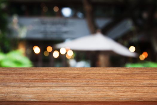 Top of brown wooden table with cafe blurred abstract background