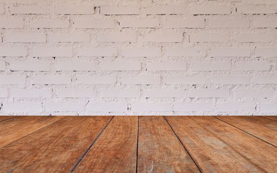 Wooden table top with brick wall decorated in coffee shop