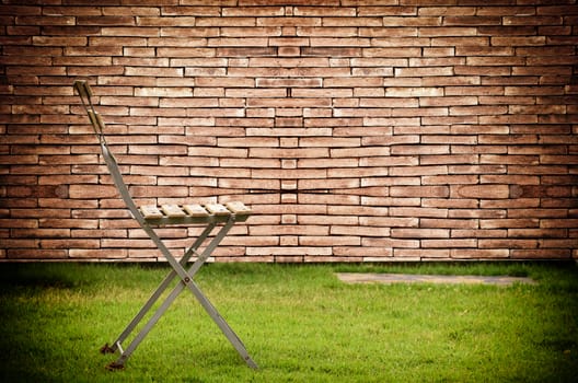 Old chair on old wall brick background