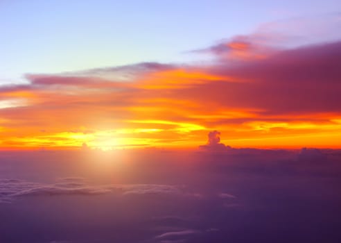 Sunset with clouds over view from airplane flying