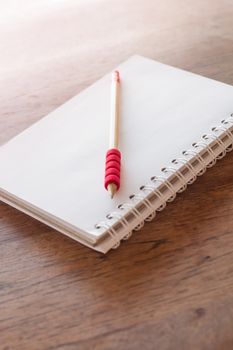 Work station with notebook and pencil with vintage filter, stock photo