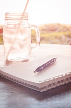 Work station with notebook and pen with vintage filter