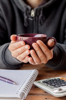 Woman hands holding a cup of coffee, stock photo