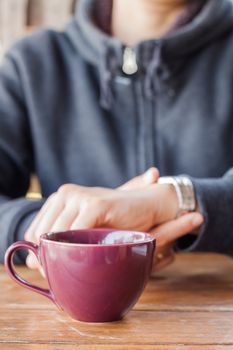 Woman checks the time on a wrist watch, stock photo