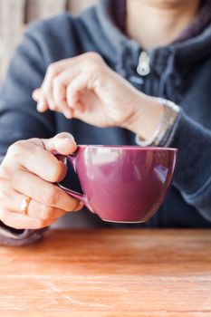 Woman checks the time on a wrist watch, stock photo