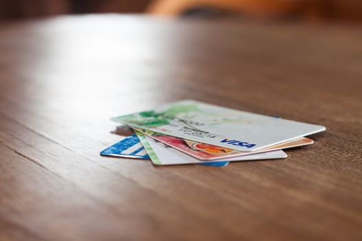 CHIANG RAI, THAILAND - March 3, 2016: Visa cards on wooden table, stock photo
