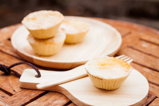 Mini pies on wooden plate, stock photo