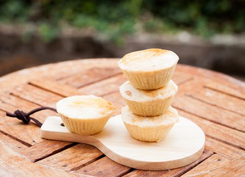 Mini pies on wooden plate, stock photo