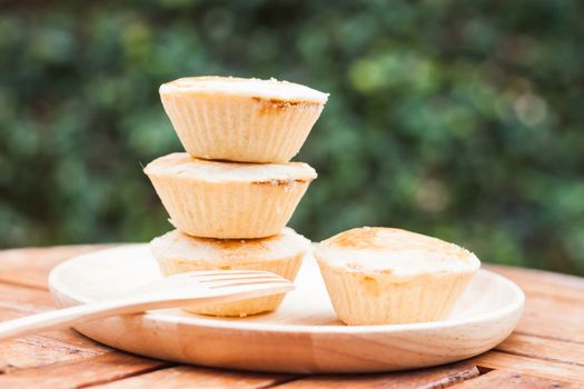 Mini pies on wooden plate, stock photo