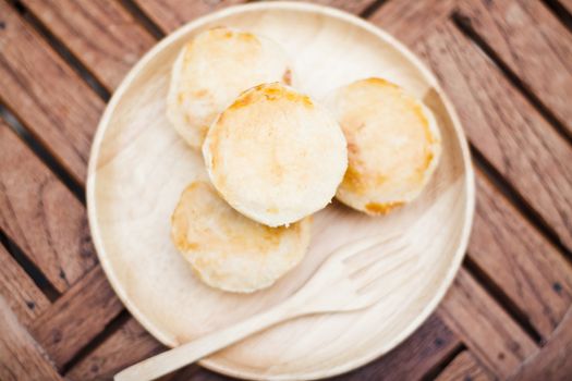 Mini pies on wooden plate, stock photo