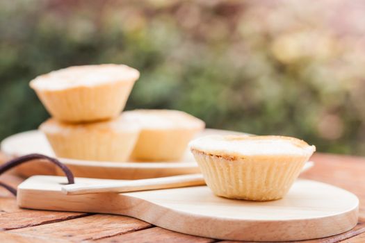 Mini pies on wooden plate, stock photo