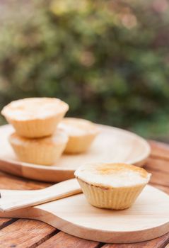 Mini pies on wooden plate, stock photo