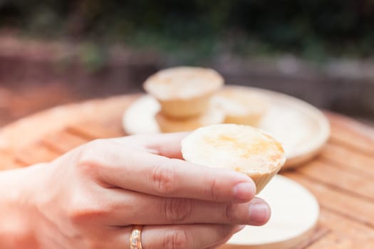 Woman's hand holding mini pies, stock photo