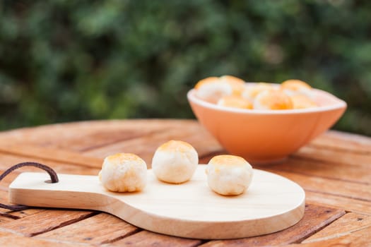 Mini Chinese cakes on wooden plate, stock photo