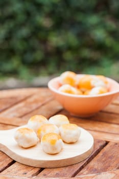 Mini Chinese cakes on wooden plate, stock photo