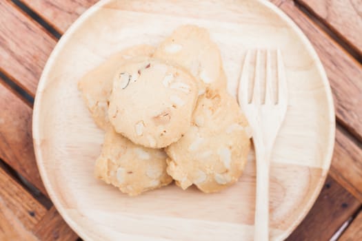 Cashew cookies on wooden plate, stock photo