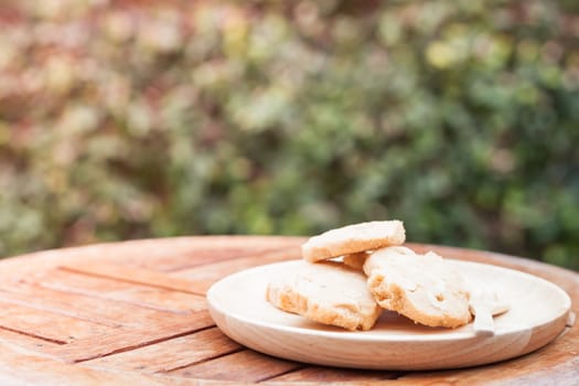 Cashew cookies on wooden plate, stock photo