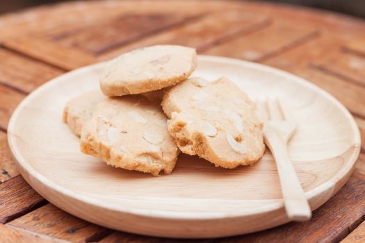 Cashew cookies on wooden plate, stock photo