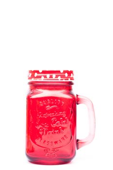 Red mason glass on white background, stock photo