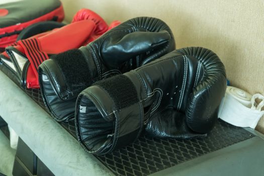 A pair of used black boxing gloves.