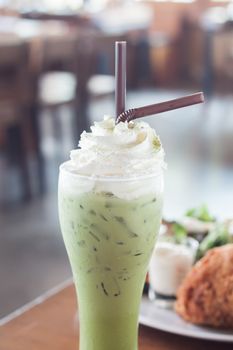 Iced green tea with whipped cream, stock photo