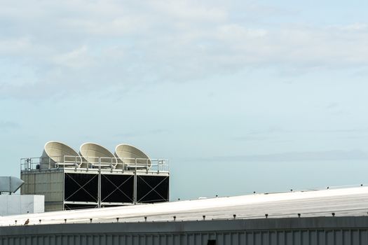 Communication Satellite dish on the roof on a building.