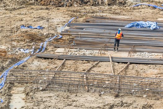 Construction workers are preparing pump for concrete for pouring.