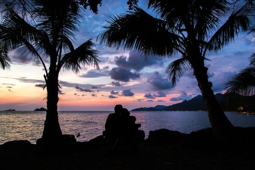 Silhouettes at sunset on the beach.